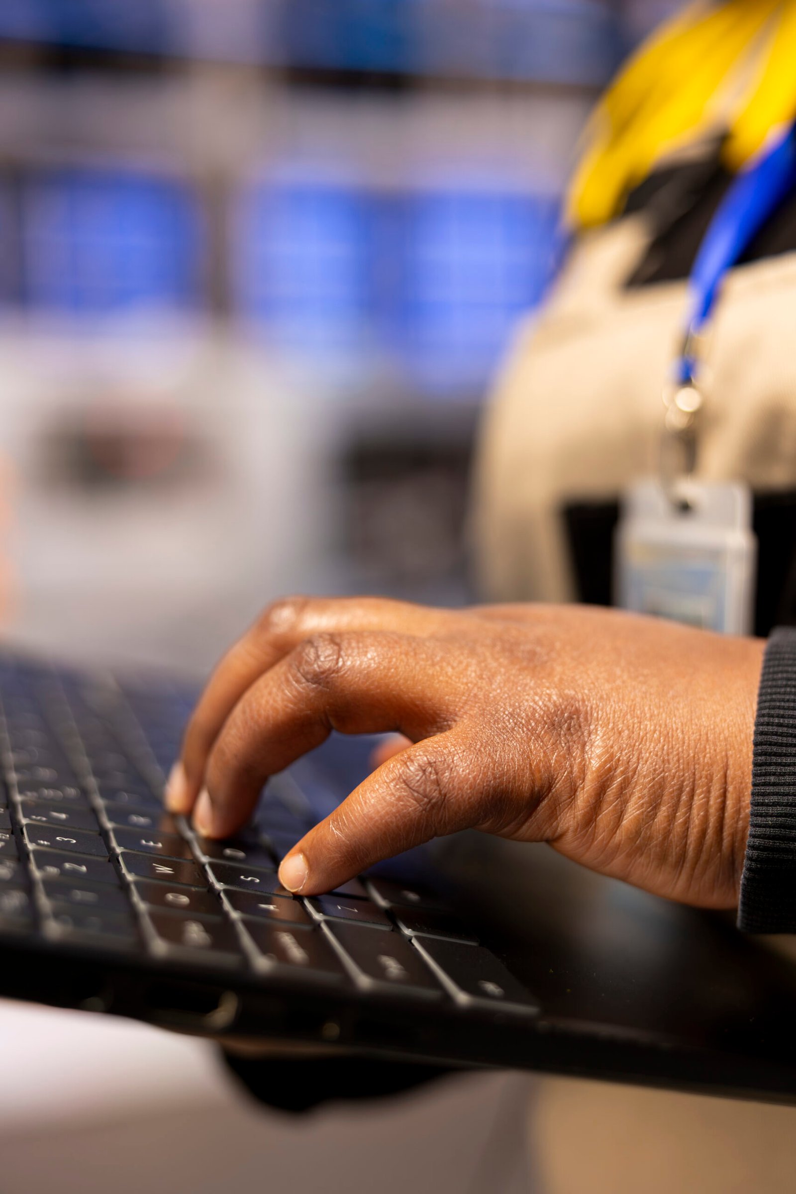 Female Engineer Optimizing Industrial Manufacturing Processes African American manufacturing engineer operates a laptop to manage industrial automation systems. Female technician ensures production quality and oversees machine performance in a factory.